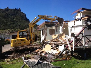 Digger at work on house demolition